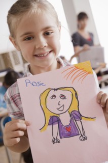 Girl (6-7) showing his drawing. 
Photo : Rob Lewine