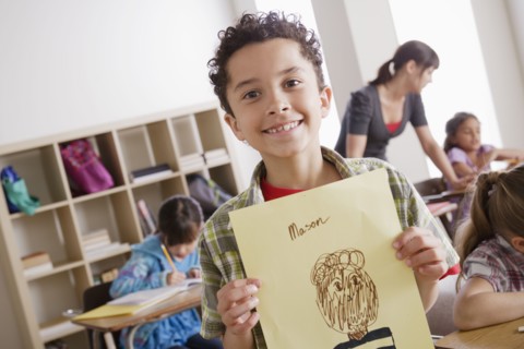 Boy (8-9) showing his drawing. 
Photo : Rob Lewine