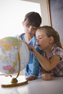Schoolgirls (6-7,8-9) with globe. 
Photo: Rob Lewine