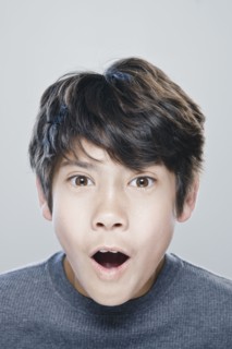 Portrait of boy (12-13) expressing surprise. 
Photo : Rob Lewine