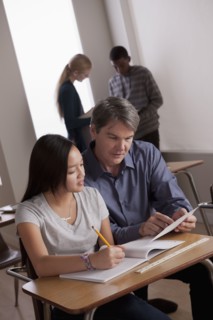 Teacher with teenage students (14-15) at school. 
Photo : Rob Lewine