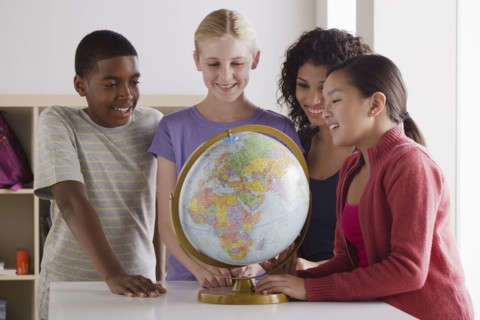 Portrait of teenage students (14-15, 16-17) with globe. 
Photo : Rob Lewine