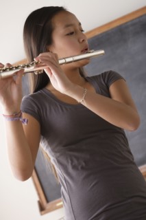 Teenage girl (14-15) playing flute. 
Photo : Rob Lewine