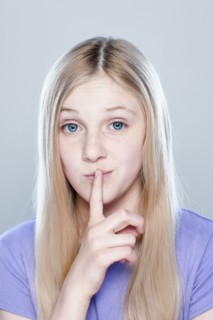 Portrait of teenage girl (14-15), studio shot. 
Photo: Rob Lewine