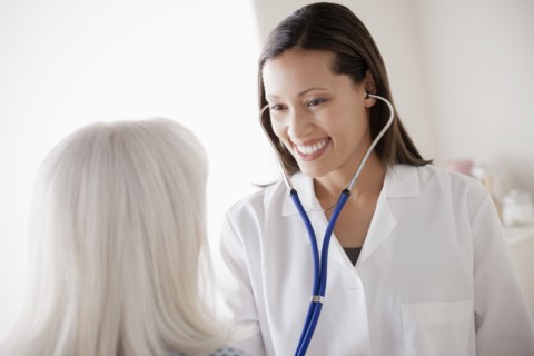 Young doctor examining senior patient. 
Photo : Rob Lewine