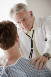 Senior doctor examining patient. 
Photo : Rob Lewine