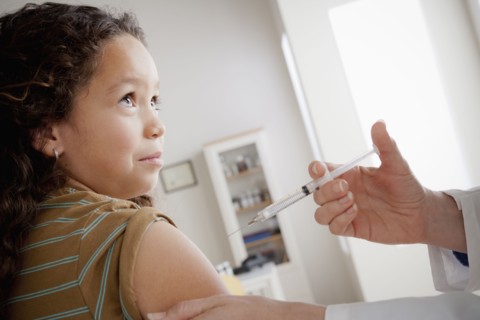 Girl (8-9) having vaccination. 
Photo : Rob Lewine