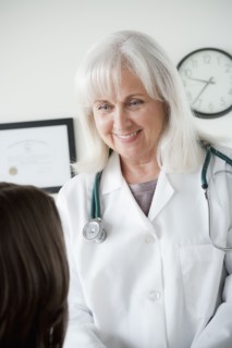 Senior doctor talking with patient. 
Photo : Rob Lewine