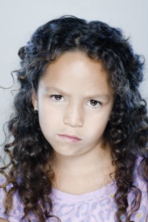 Portrait of confused girl (8-9), studio shot. 
Photo : Rob Lewine