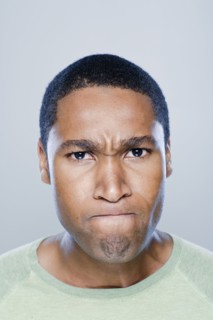 Portrait of young angry man, studio shot. 
Photo : Rob Lewine