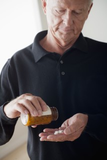 Senior man taking pills. 
Photo : Rob Lewine