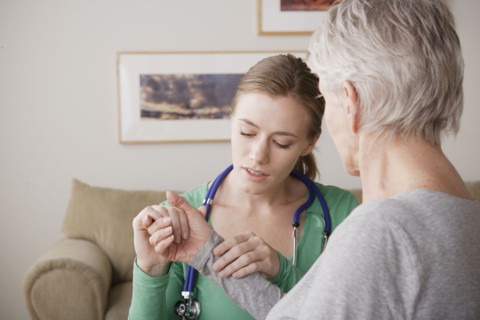 Young female nurse taking pulse of senior woman. 
Photo: Rob Lewine