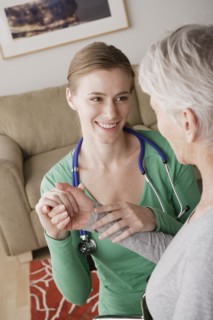 Young female nurse taking pulse of senior woman. 
Photo: Rob Lewine
