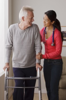 Young female nurse taking care of senior man with walker. 
Photo : Rob Lewine