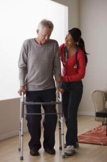 Young female nurse taking care of senior man with walker. 
Photo: Rob Lewine