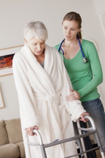 Young female nurse taking care of senior woman with walker. 
Photo: Rob Lewine