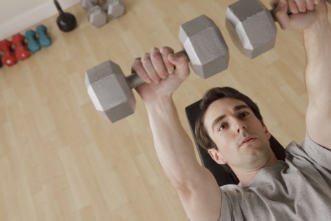 Young man exercising with dumbbell. 
Photo: Rob Lewine