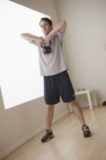 Young man exercising with weight. 
Photo : Rob Lewine