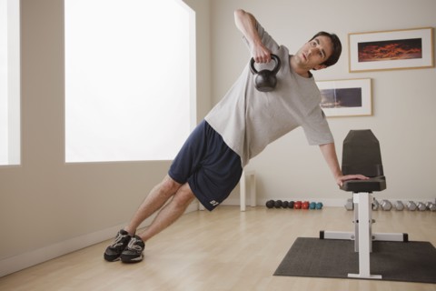 Young man exercising with weight. 
Photo : Rob Lewine