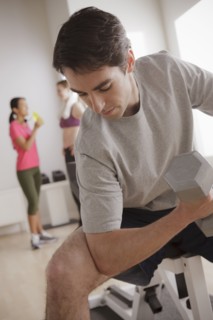 Young man exercising with dumbbell. 
Photo : Rob Lewine