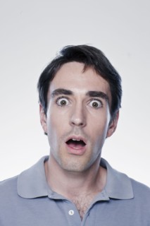 Portrait of scared man, studio shot. 
Photo : Rob Lewine