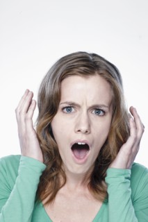 Portrait of shocked young woman, studio shot. 
Photo : Rob Lewine