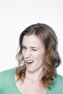 Portrait of young woman blinking eye, studio shot. 
Photo : Rob Lewine