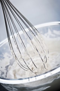 Whisking cream, studio shot. 
Photo : Elena Elisseeva