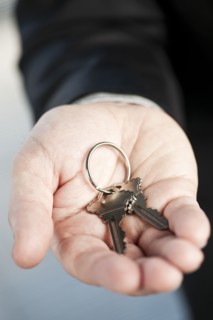 Home keys on hand, studio shot. 
Photo : Elena Elisseeva