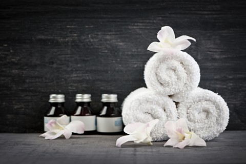 Still life with bottles, flowers and towels. 
Photo : Elena Elisseeva
