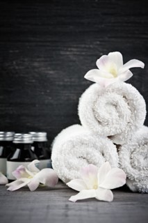 Still life with bottles, flowers and towels. 
Photo : Elena Elisseeva