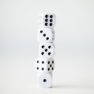 Dices on white background, studio shot. 
Photo : Jessica Peterson