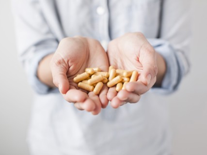 Woman showing medicine pills. 
Photo : Jessica Peterson