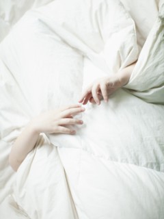 Boys hands (2-3) sticking out from under quilt. 
Photo: Jessica Peterson