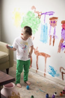 Toddler boy (2-3) painting on wall. 
Photo : Jessica Peterson