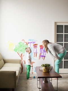 Mother telling toddler boy (2-3) off for painting on walls. 
Photo : Jessica Peterson
