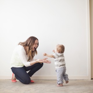 Young mother assisting baby boy (6-11 months) in first steps. 
Photo: Jessica Peterson