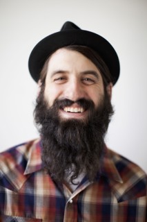 Profile of male character wearing long beard, hat and lumberjack shirt. 
Photo : Jessica Peterson