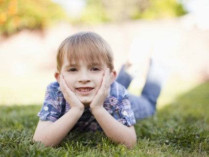 Outdoor portrait of happy young boy (6-7) . 
Photo: Jessica Peterson