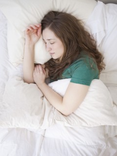Young woman sleeping in bed. 
Photo : Jessica Peterson