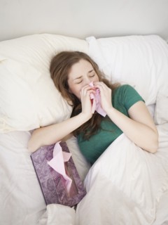 Ill young woman staying in bed. 
Photo : Jessica Peterson