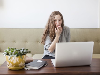 Young woman blowing kiss while using laptop. 
Photo : Jessica Peterson