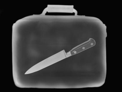 X-ray image showing briefcase containing knife. 
Photo : Calysta Images