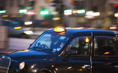 UK, London, Black cab at night.