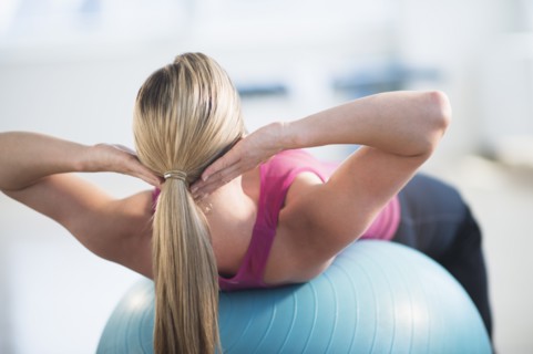 Woman exercising on fitness ball.
