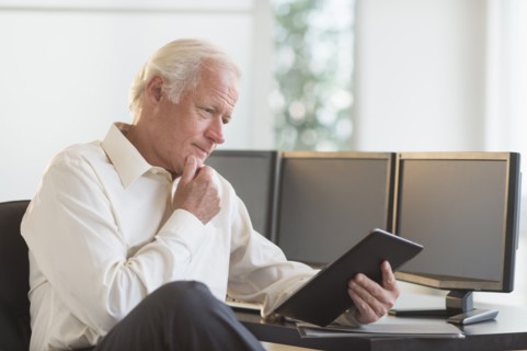 Senior man using tablet pc.
