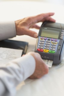 Man inserting credit card in credit card machine.