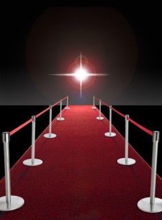 Glowing star above red carpet.