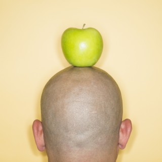 Back view of man with apple on head.