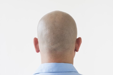 Back view of shaved businessman.